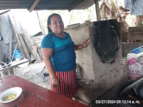 Juana showing her Improved Oven