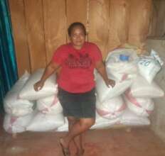Osneyda stands in front of her harvest