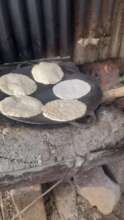 The Tortillas cooking in a small metal griddle