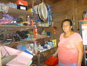 Tomasa stands in her store