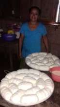 Rosa showing off her products, cornbread (bollos a