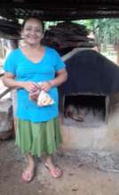 Rosa in front of her oven