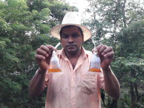 Porfirio holding bags of tested water.