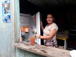 Eugenia serving fresh juice made with clean water.