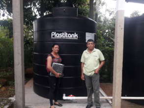 Geovany and Arlen in front of the water system.