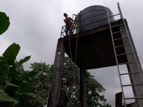 The community water tank is high off the ground.