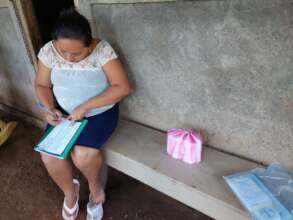 Photo of the CAPS president wife keeping records