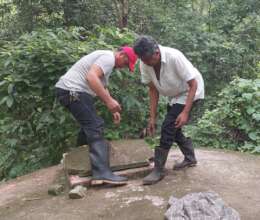 CAPS member checking the water storage tank