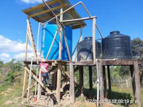 Serapio checking the water storage tanks