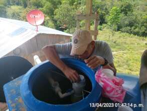 Serapio placing the chlorine tablets to the water