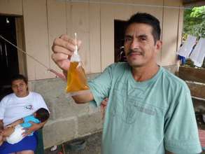 Miguel holds up contaminated crude water in 2013