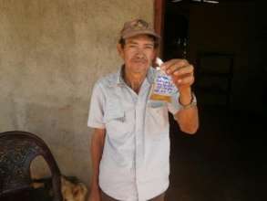 Silvio holds a sample of the drinking water