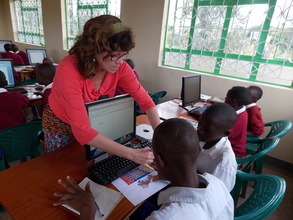 Laura Groo helps Kambiti students with keyboarding