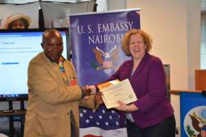 A teacher recieves a cerficate at the US embassy