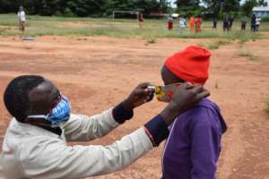 James providing a mask to one of our students