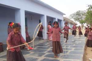 Girl children playing skipping rope