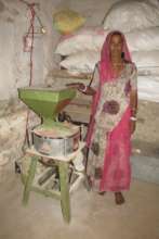 Chandu Devi with her flour-grinding mill