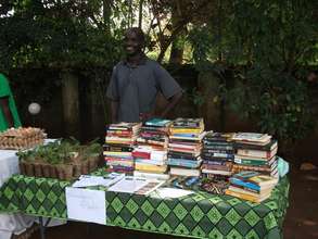 Fred Kyakonye busy selling herbs and used books
