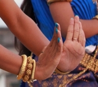 A dancers hands create the Suprech (prayer)