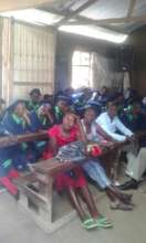 Guardians and pupils listening to the speeches