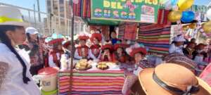 Mothers act out region dress at food Kiosk