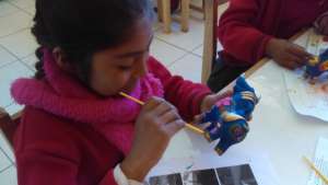 Student painting the Bull (Torro) for a guest.