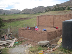 Setting the adobe walls of the sheep pen