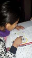 Reading the lesson- then writing her understanding