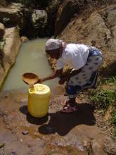Woman fetching water from the Kitui Spring