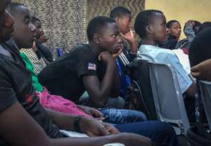 Students watch Isano Isangiwe's performance.