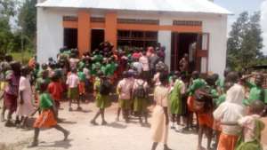 children lineup for food at EDAPO new kKitchen