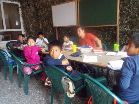 Saul teaching younger students in La Academia