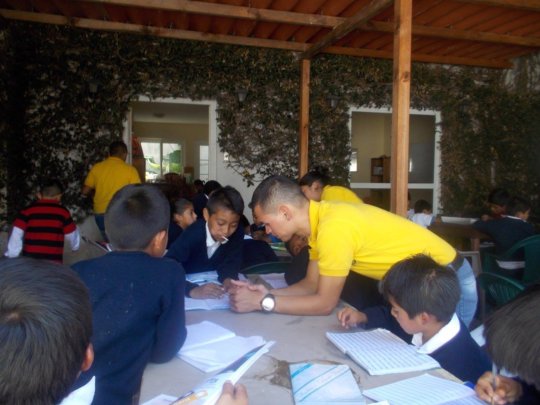 Saul teaching younger students in La Academia