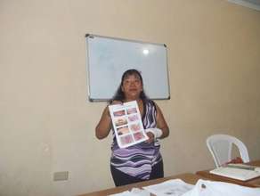 Marisol showing the students images of STDs