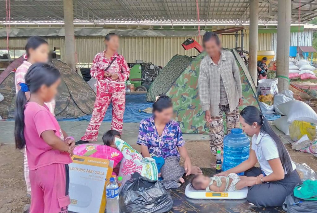 Checking on mother and baby at a displacement site