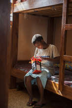 A Sega student opens a solar light package