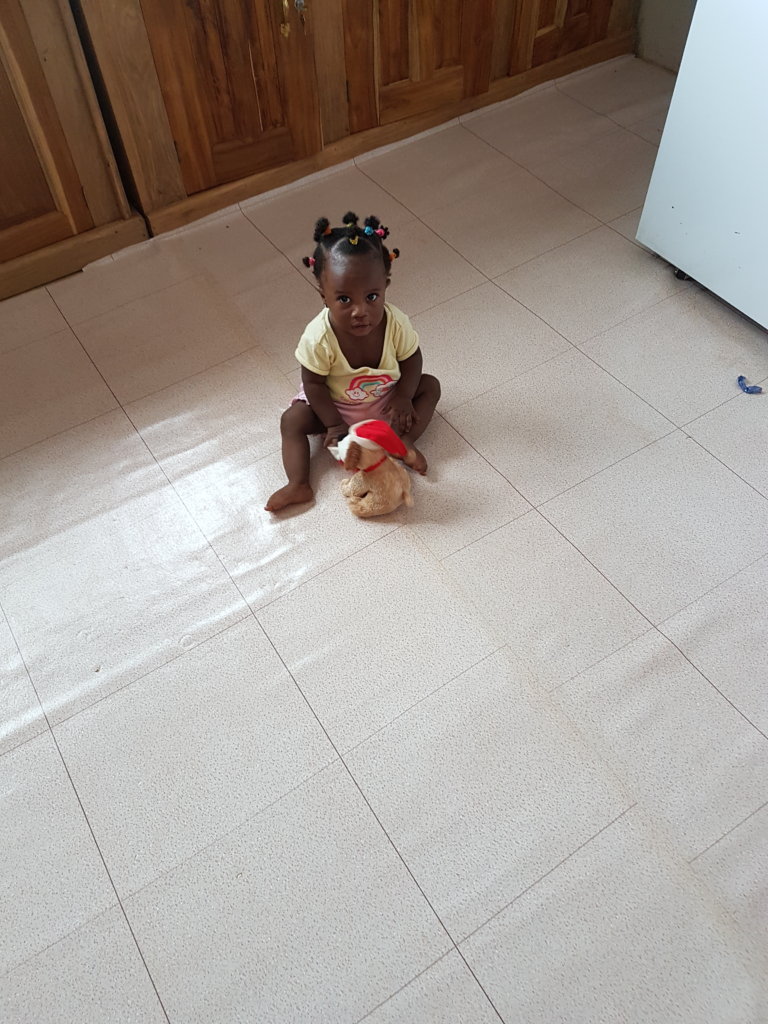 Theresah at 7 months old playing with her doll