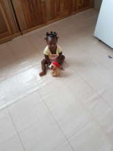 Theresah at 7 months old playing with her doll