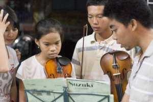 Vy (center) in 2013 with our music teacher Tuan