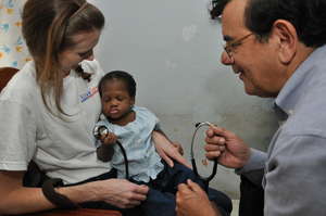 A child from the home with AmeriCares staff