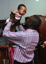 A child from the home with their staff