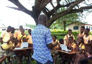 Outdoor computer class guided by a librarian.