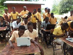 Pupils in Volta Region practice using computers.