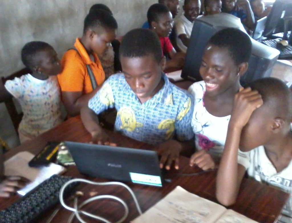 Patient children wait in line to use the laptops.