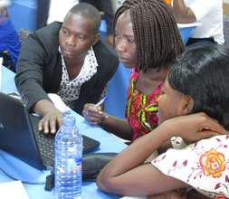 Teachers practise using laptops.