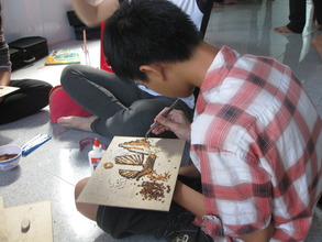 Nhat creating a rice painting.