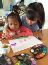 Teacher Trang helping a student, Son Tan, Vietnam