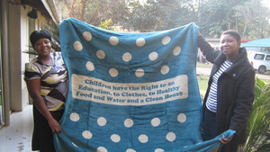 Staff pose with the blanket with its key message.