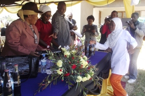 Minister  Simba awarding a computer a student