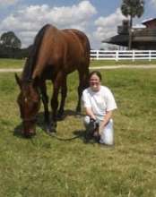 Jack enjoys some nice green grass with a volunteer